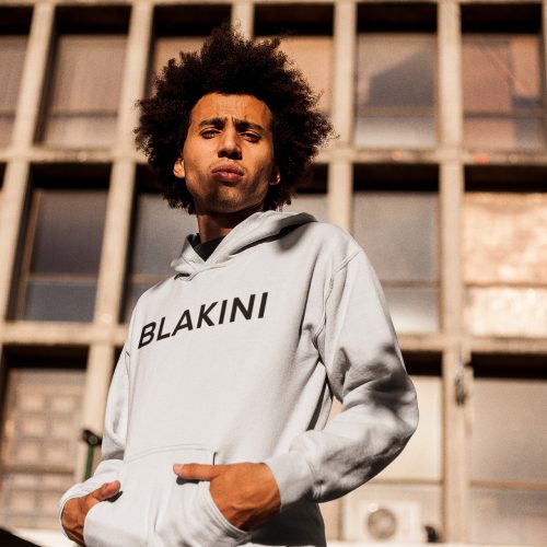 man-wearing-a-pullover-hoodie-afro-mockup-while-outside-an-abandoned-building-a18946
